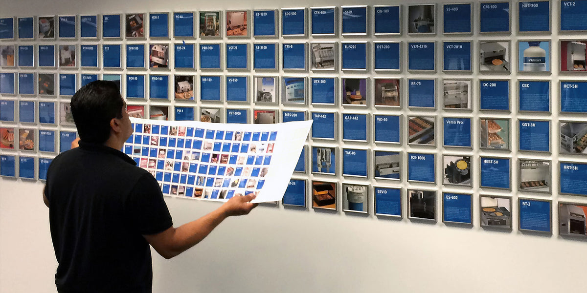Corporate framing and installation project for A.J. Antunes & Co. headquarters featuring organized wall display grid.