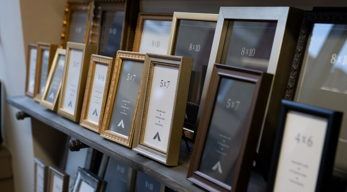 Handcrafted custom picture frames displayed at Masterpiece Framing + Imaging showroom.