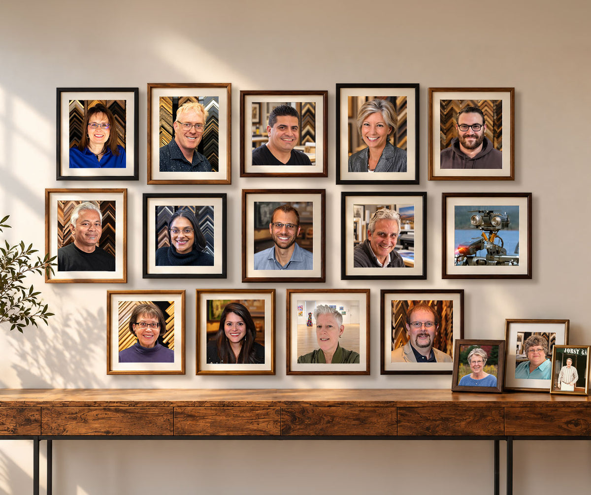 Custom framed portraits of the Masterpiece Framing + Imaging team displayed in a gallery wall arrangement.