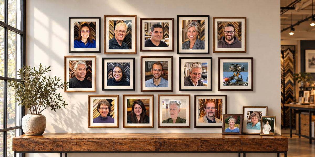 Custom framed portraits of the Masterpiece Framing + Imaging team displayed in a gallery wall arrangement.