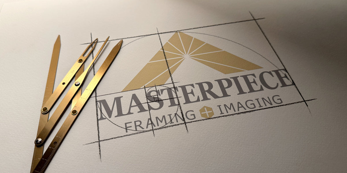 Masterpiece Framing + Imaging logo sketched using golden ratio principles alongside traditional drafting tools.