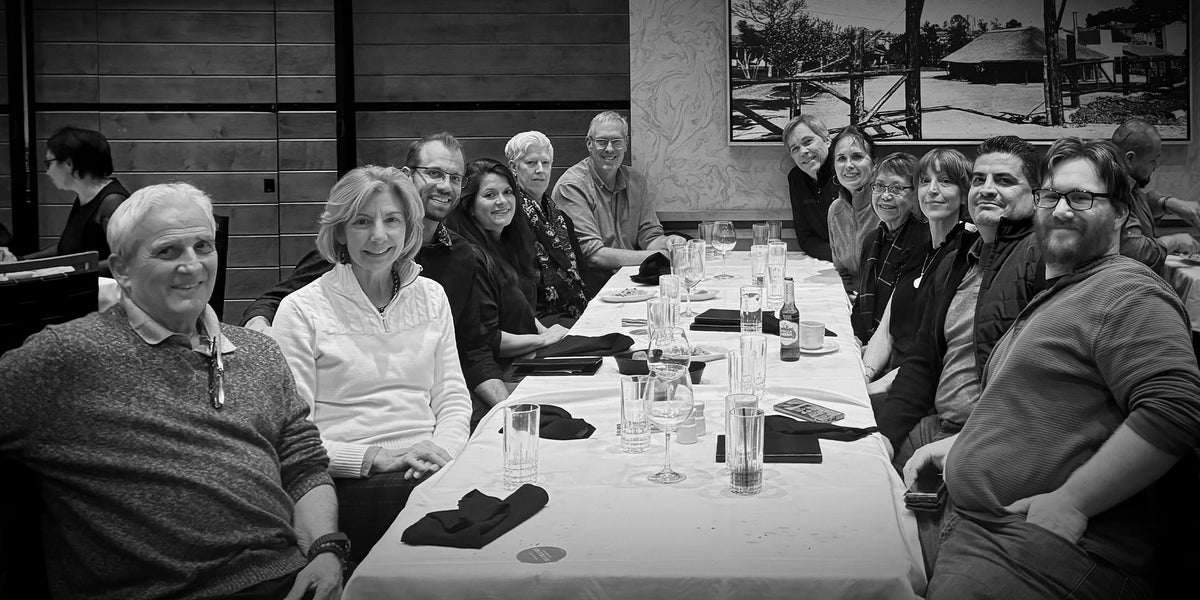 Masterpiece Framing + Imaging team gathered for dinner, reflecting company culture and purpose since 2002.