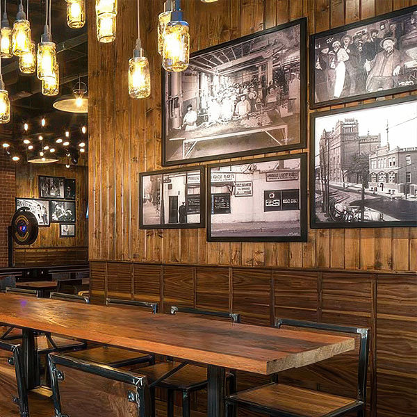 Large-scale framing installation featuring historic black-and-white photography in a restaurant interior.